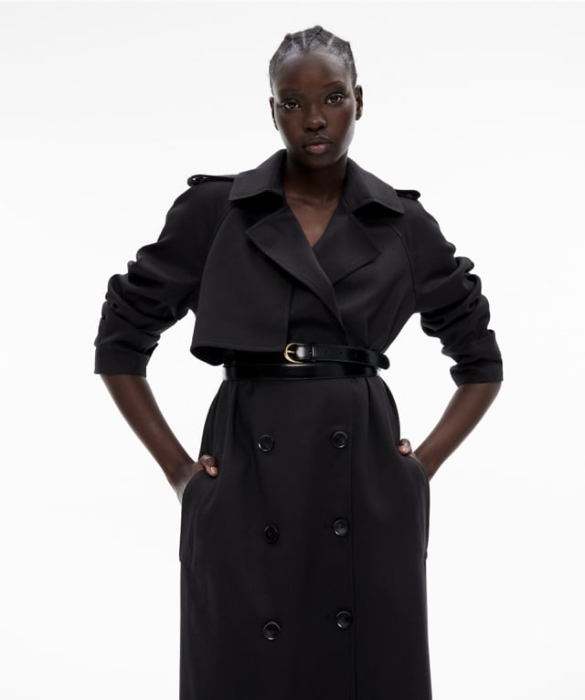 Woman in a black trench coat