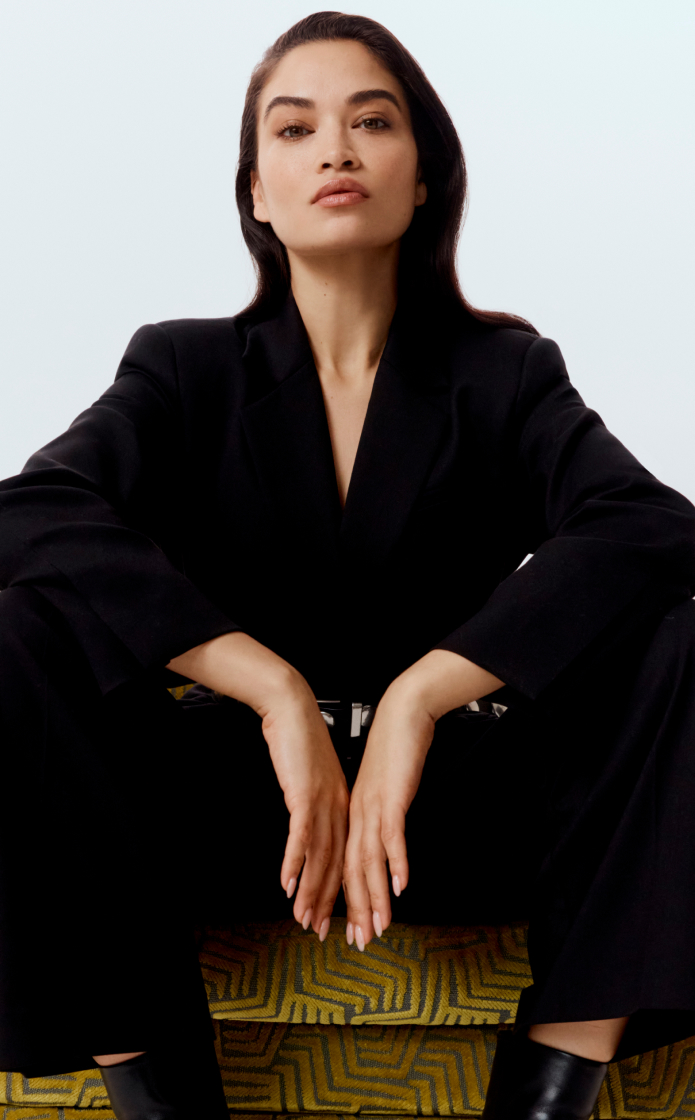 Shanina in black wool blend single-breasted boxy blazer, black wool blend relaxed rise trouser and black studded leather belt