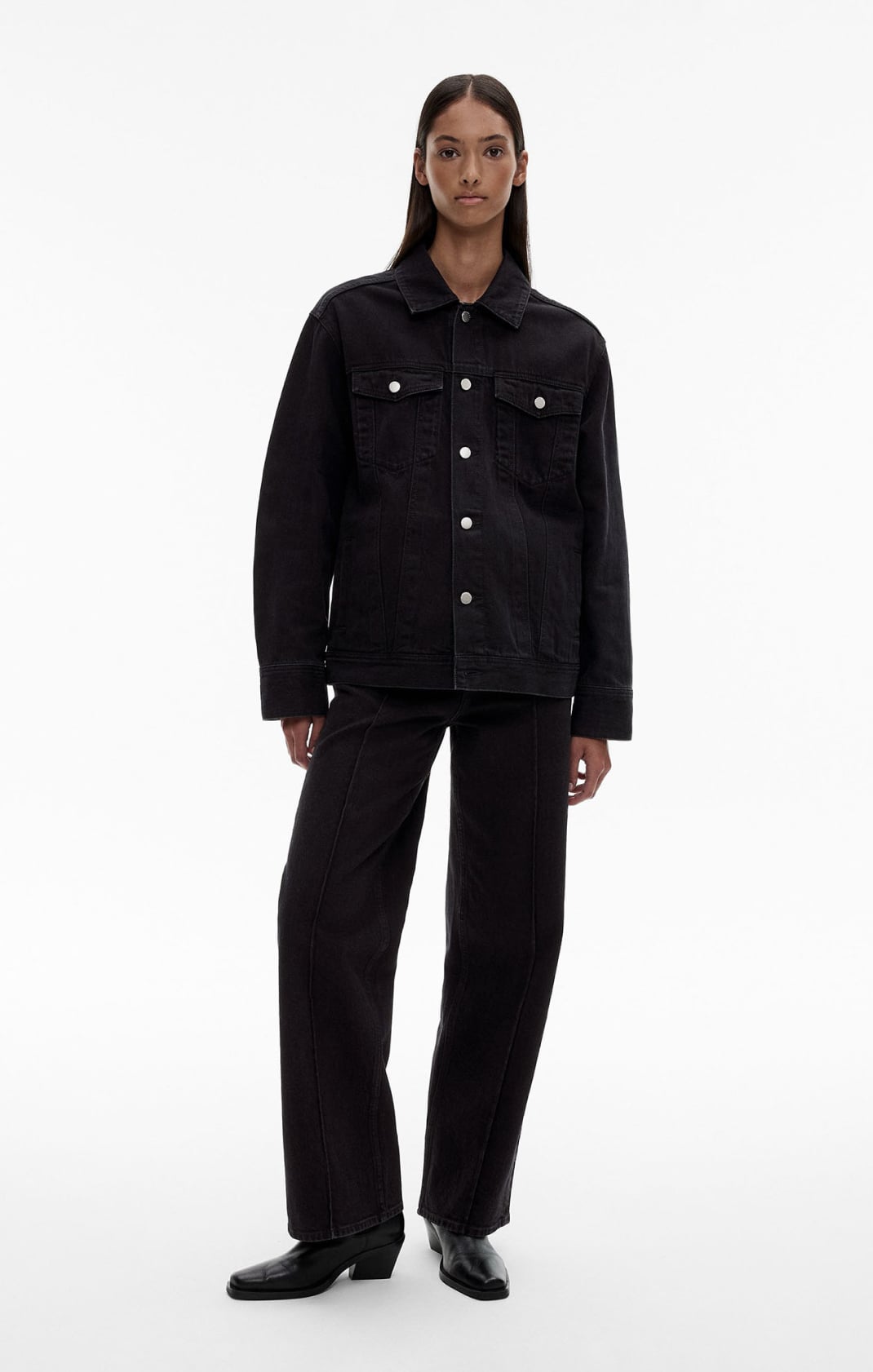 Woman in black denim jacket and black denim jeans