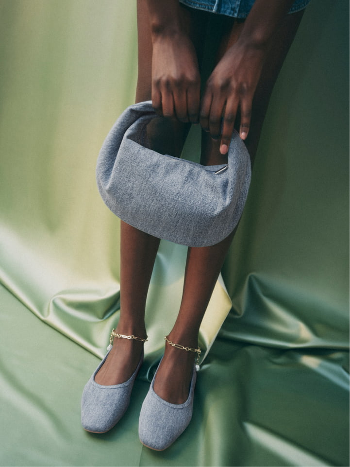 Woman wearing vintage wash alyssa ballet flats and vintage wash romy mini hobo bag